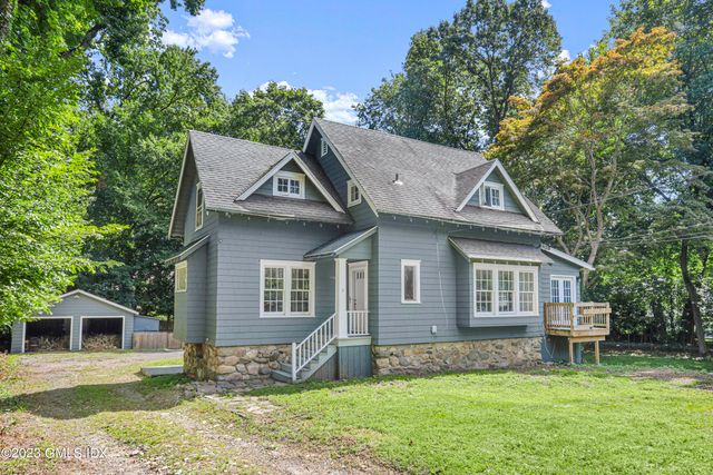 a front view of a house with a garden and yard