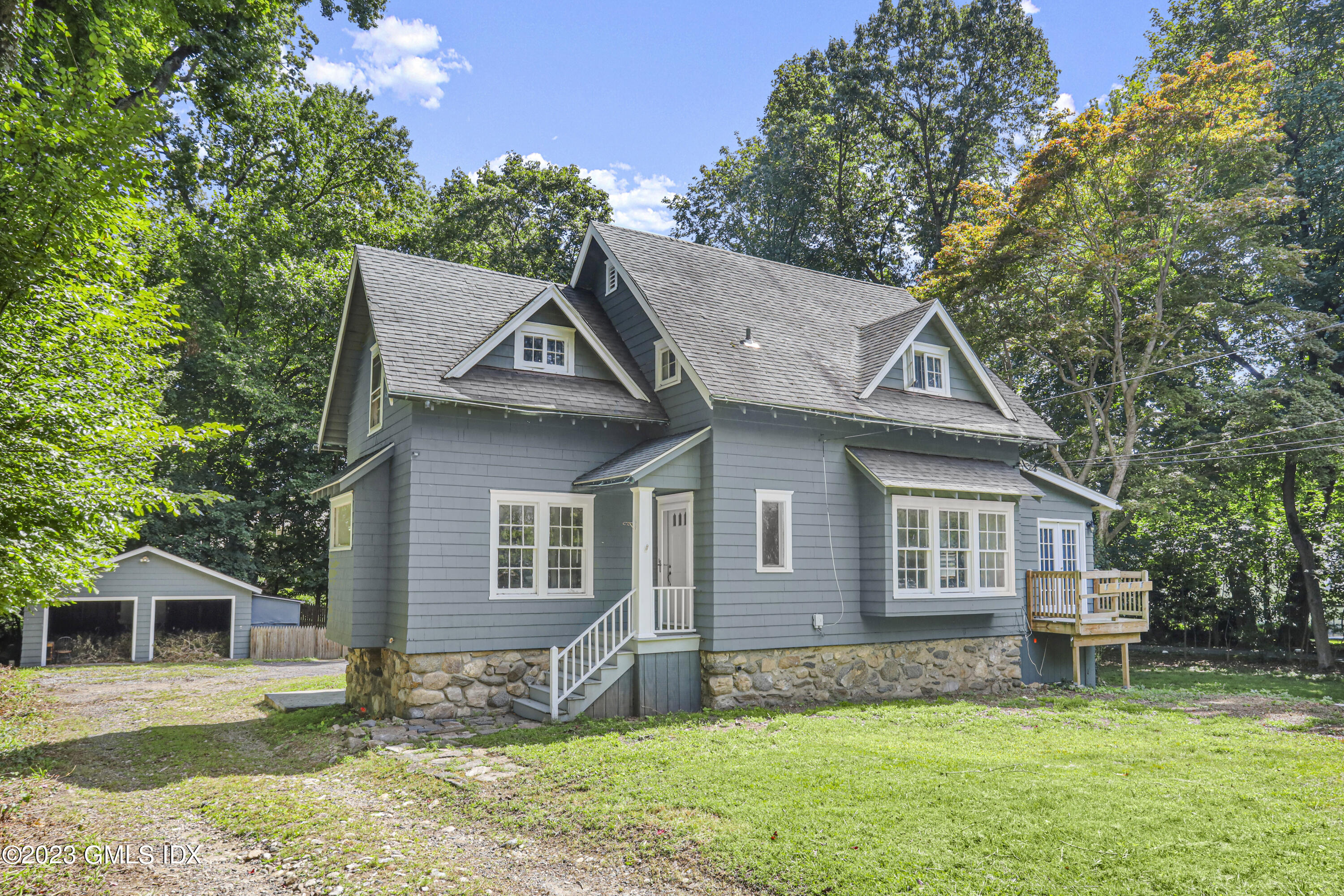 33 Breezemont Avenue Riverside, CT 06878 - Photo 6 of 31 a front view of a house with a garden and yard