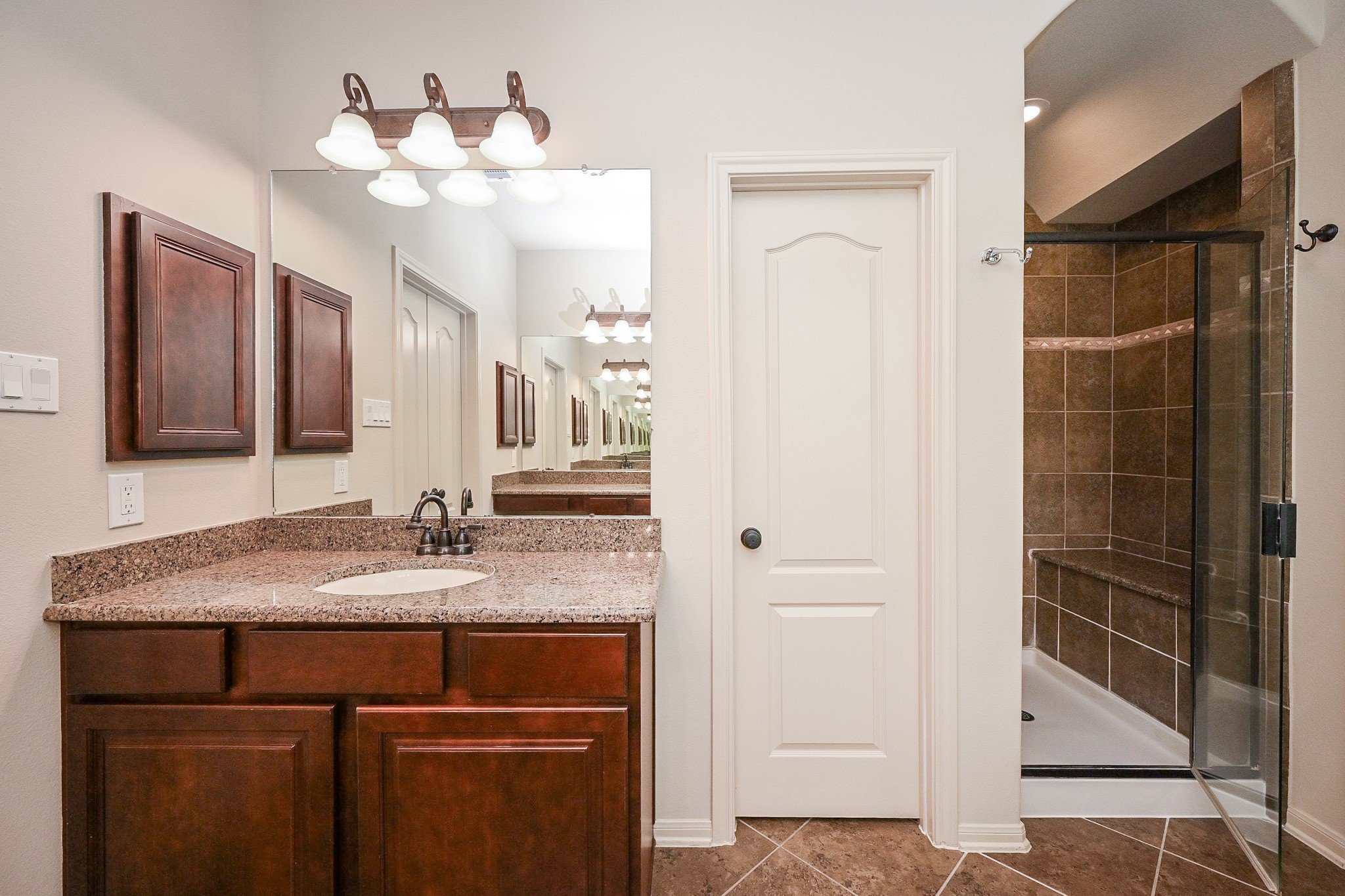 19 Sandwell Place Spring, TX 77389 - Photo 22 of 33 Primary en-suite with glass enclosed shower, dual vanities with generous counter and storage space