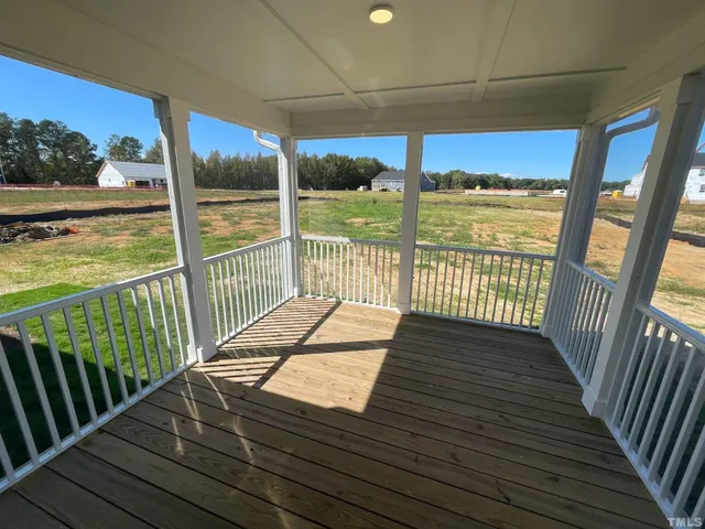 a view of a balcony with wooden floor