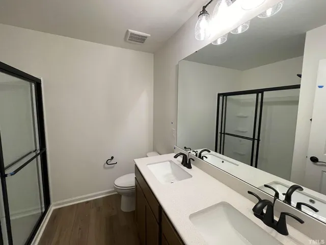 a bathroom with a sink toilet and mirror