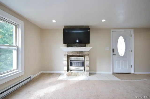a living room with fireplace furniture and a flat screen tv