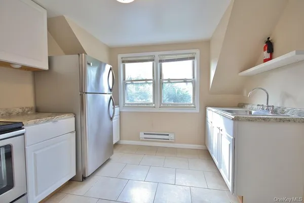 a kitchen with a refrigerator and a sink