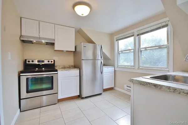 a kitchen with a stove a sink and a refrigerator