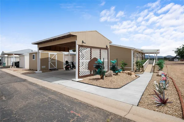 a view of a house with entertaining space and a small yard