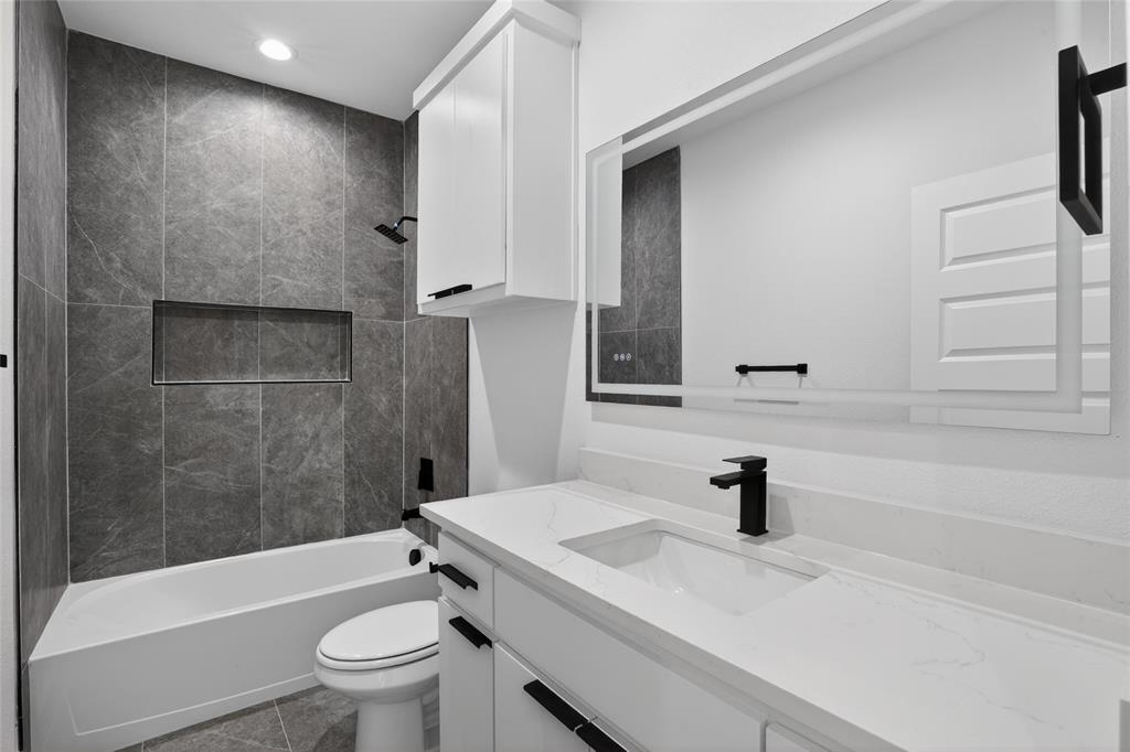 2007 North Montclair Avenue Dallas, TX 75208 - Photo 25 of 31 a bathroom with a sink a toilet and shower