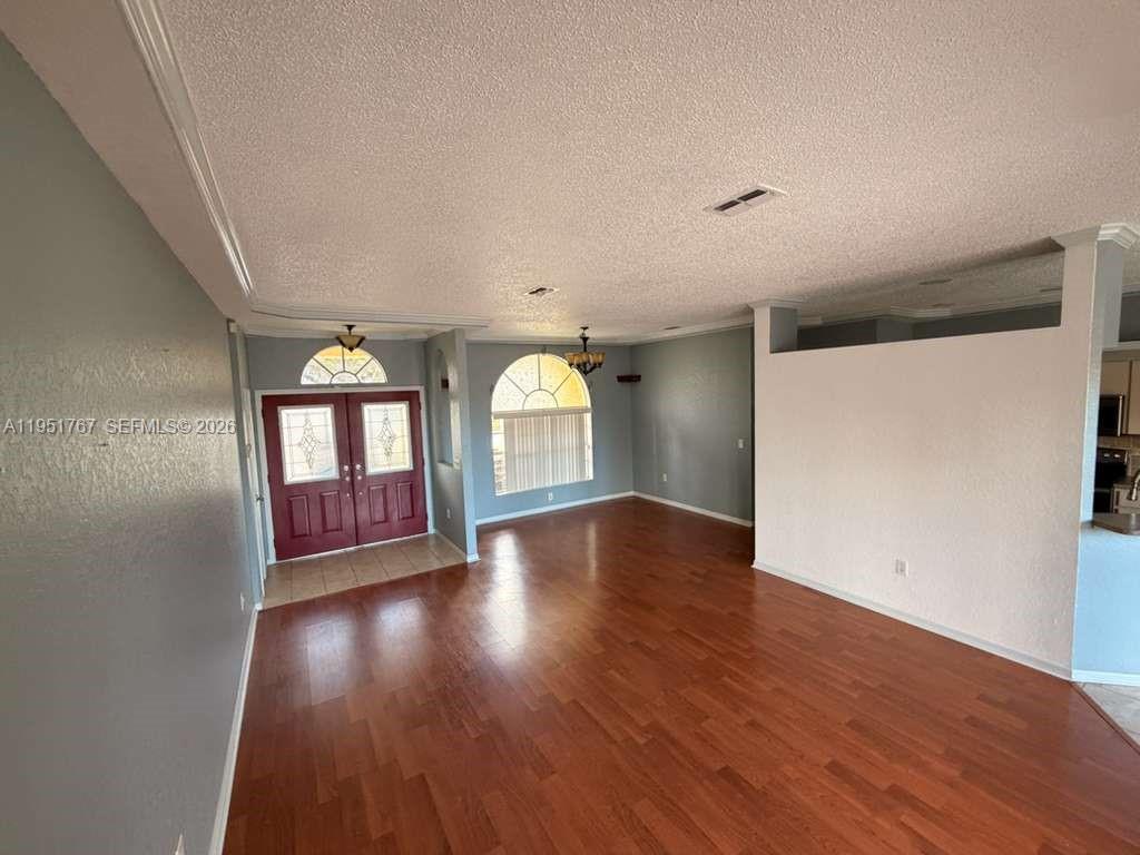 6229 Gainsboro Avenue Spring Hill, FL 34609 - Photo 12 of 25 an empty room with wooden floor and windows