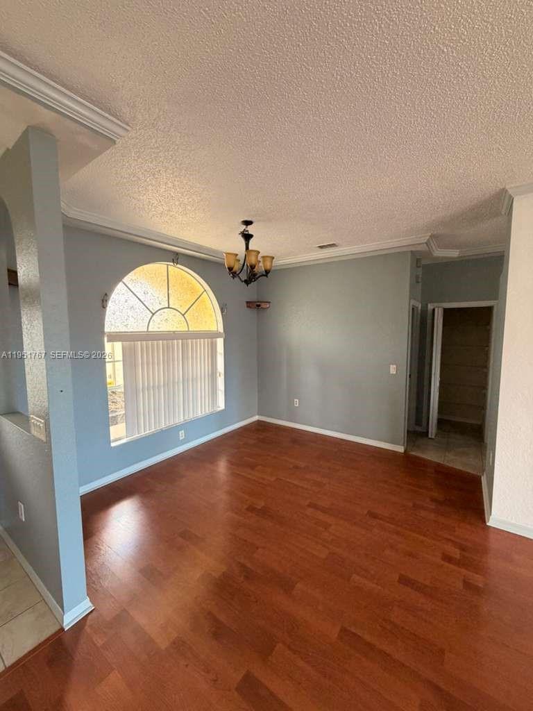 6229 Gainsboro Avenue Spring Hill, FL 34609 - Photo 14 of 25 an empty room with wooden floor and windows