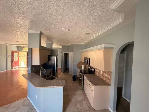a living room with furniture a flat screen tv and a large window