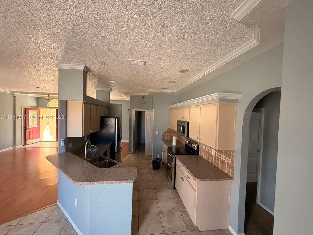 6229 Gainsboro Avenue Spring Hill, FL 34609 - Photo 16 of 25 a living room with furniture a flat screen tv and a large window