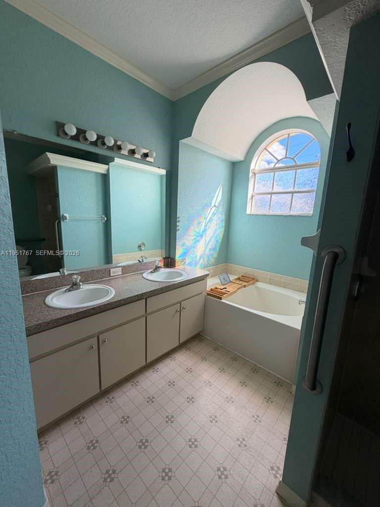 6229 Gainsboro Avenue Spring Hill, FL 34609 - Photo 19 of 25 a bathroom with a bathtub sink and mirror