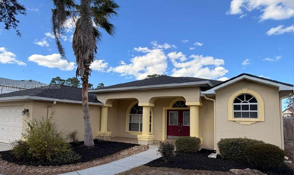 6229 Gainsboro Avenue Spring Hill, FL 34609 - Photo 2 of 25 a front view of a house with garden