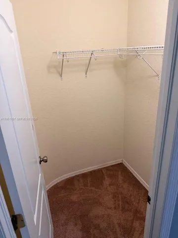 an empty room with a chandelier fan