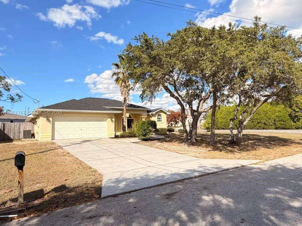 6229 Gainsboro Avenue Spring Hill, FL 34609 - Photo 5 of 25 a white house that has a tree in front of it