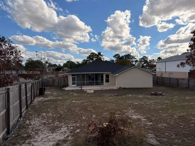a view of a house with wooden fence
