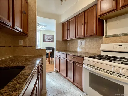 a kitchen with stainless steel appliances granite countertop a stove and a sink