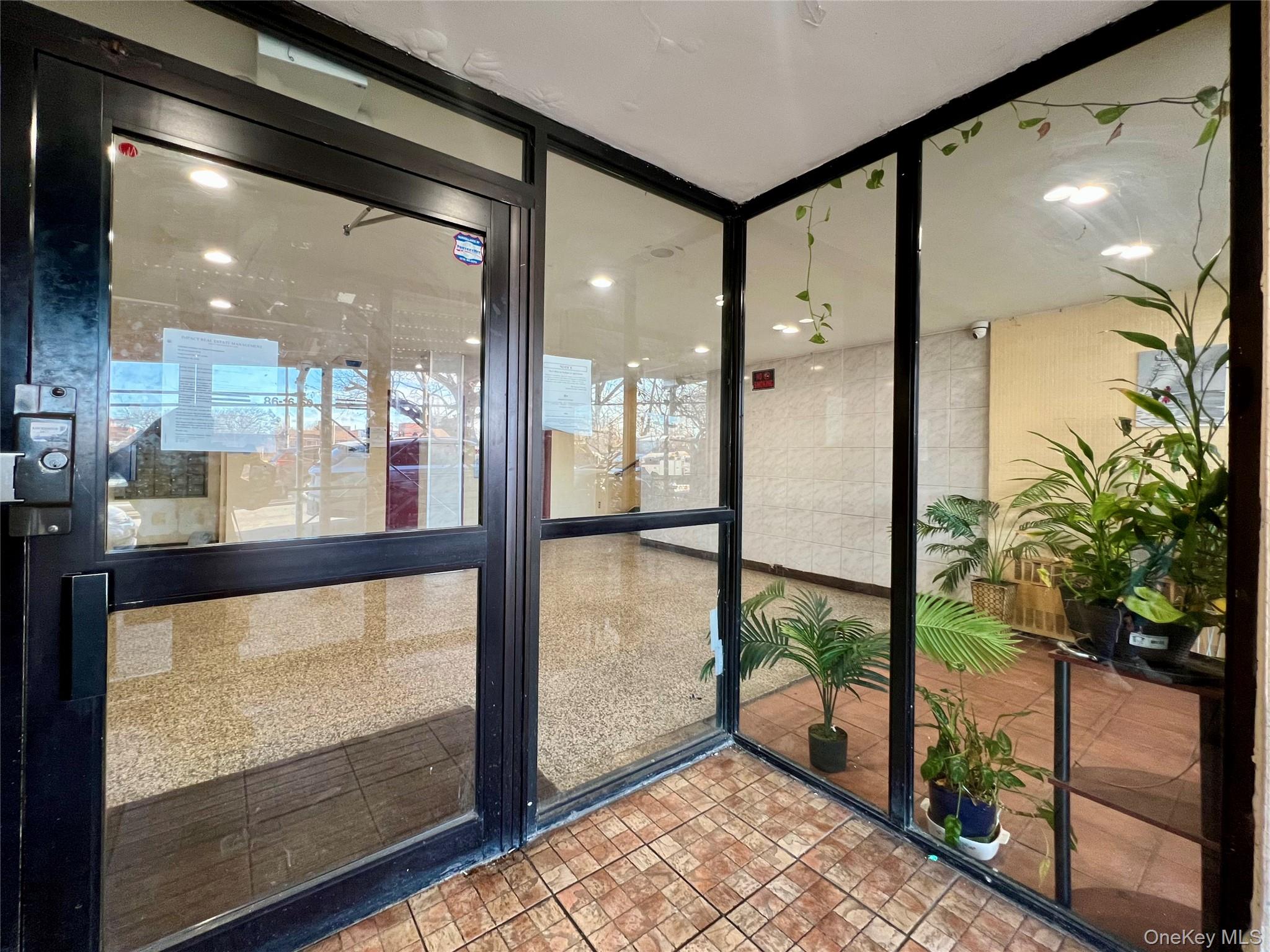 86-16 60th Avenue, Unit 2D Queens, NY 11373 - Photo 26 of 30 a view of a glass door with a balcony