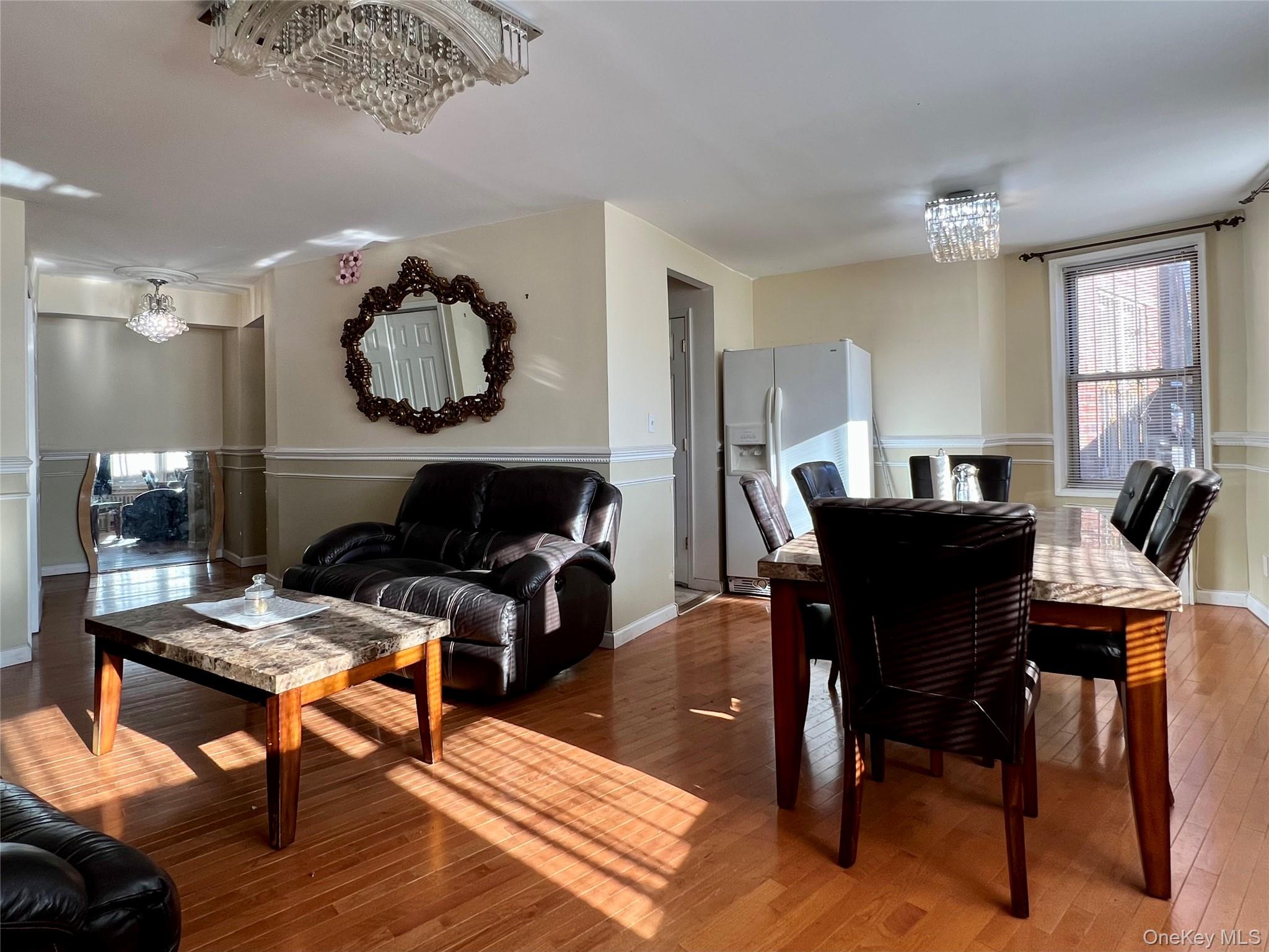86-16 60th Avenue, Unit 2D Queens, NY 11373 - Photo 8 of 30 a living room with furniture and a wooden floor