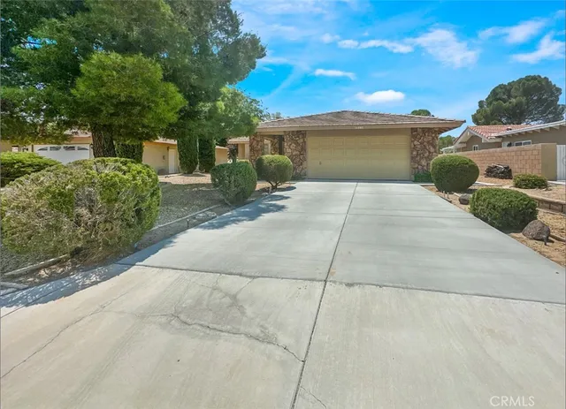 a front view of a house with a yard and a garage