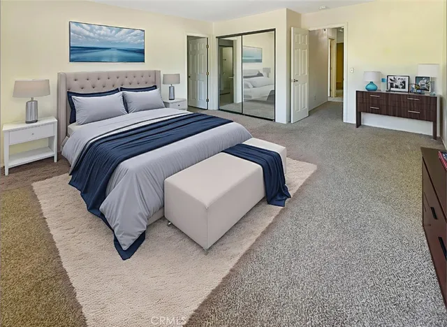 a spacious bedroom with a bed and a couch