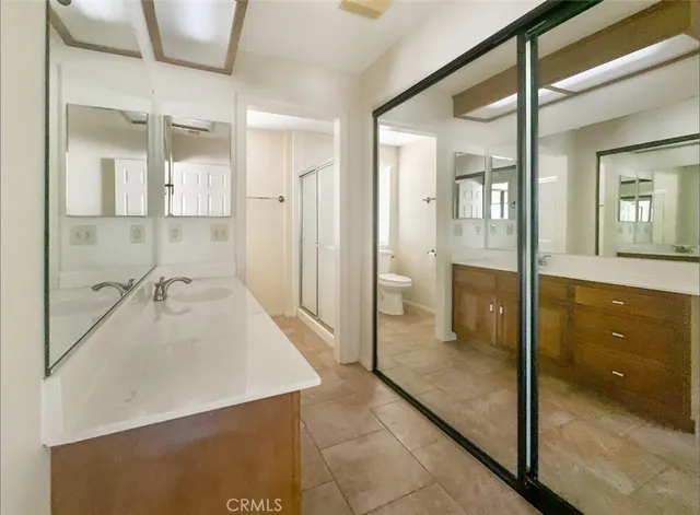a bathroom with a tub sink shower and mirror