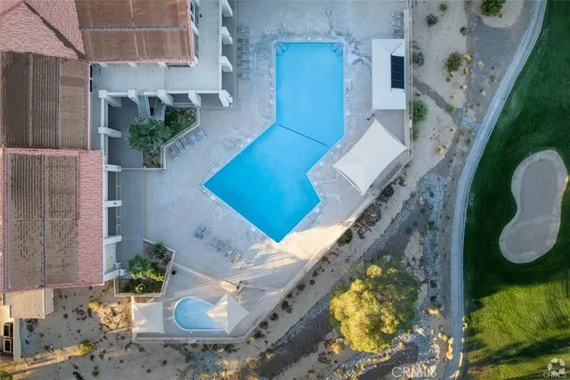 an aerial view of a house with a swimming pool