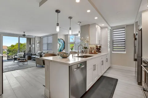 a kitchen with stainless steel appliances white cabinets and a stove top oven