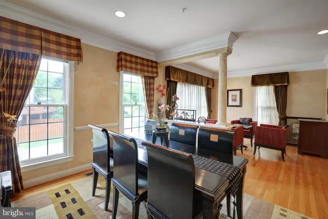 a view of a dining room with furniture window and wooden floor