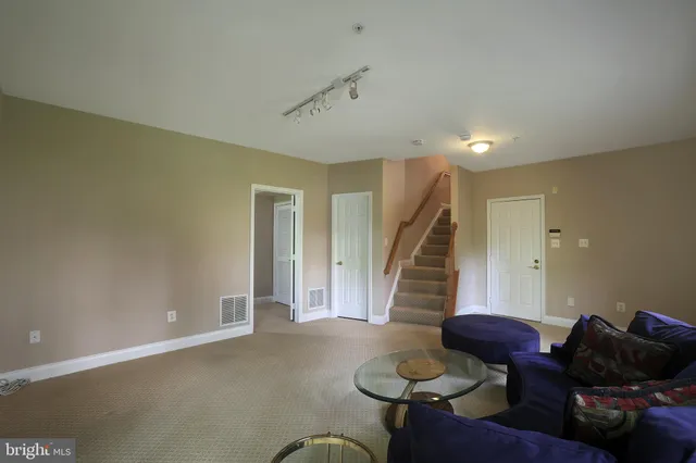 a living room with furniture and stairs