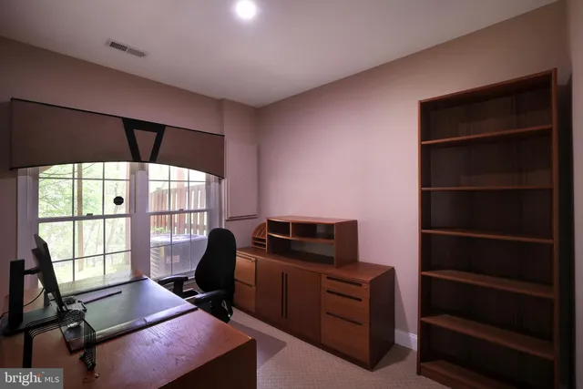 a livingroom with workspace and a window