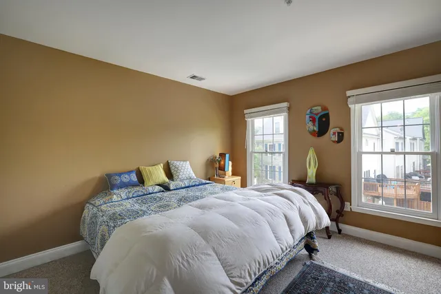 a bed sitting in a bedroom next to a window