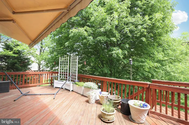 a view of a deck with two chair and wooden floor