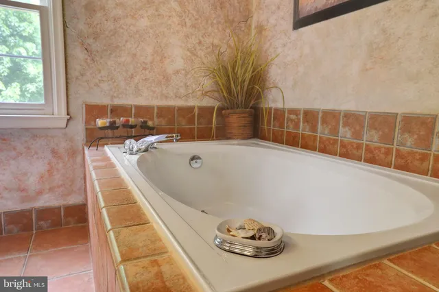 a bath tub sitting next to a white sink