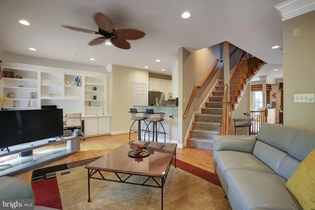 a living room with furniture and a ceiling fan