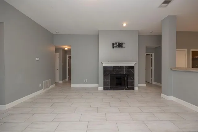 a view of an empty room with a fireplace