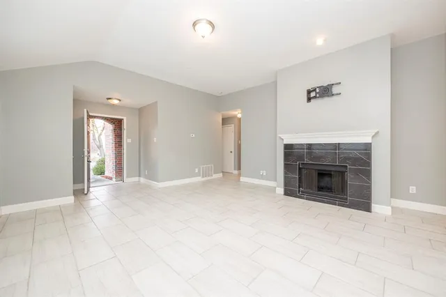 a view of an empty room with a fireplace