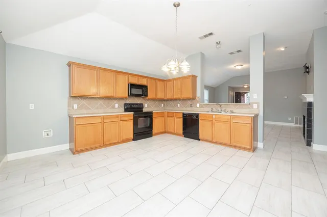 a large kitchen with cabinets and stainless steel appliances
