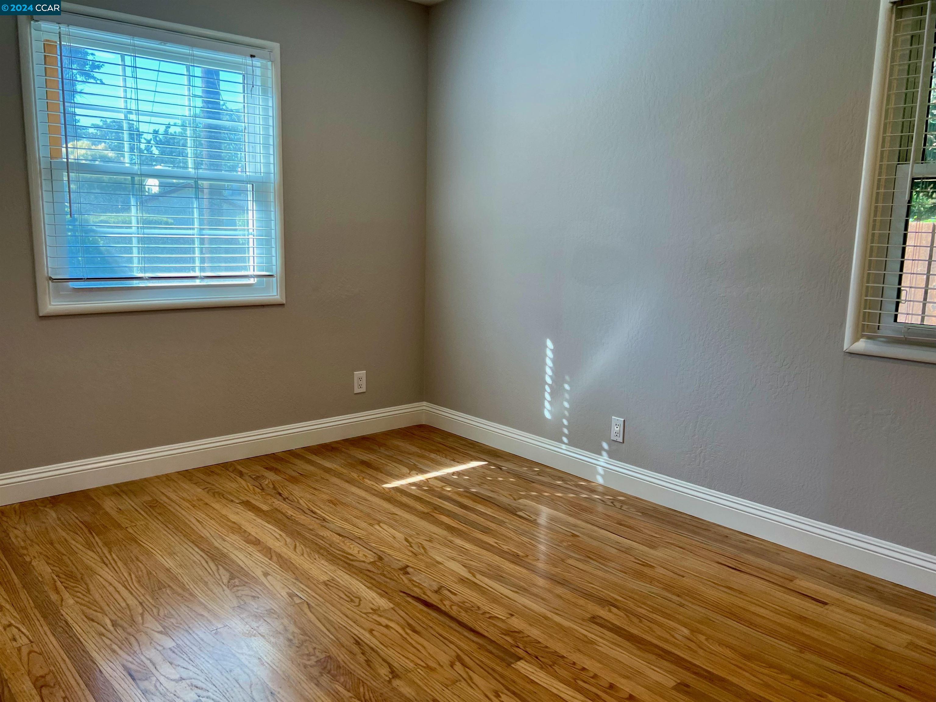 1282 Windermere Way Concord, CA 94521 - Photo 13 of 21 an empty room with wooden floor and windows