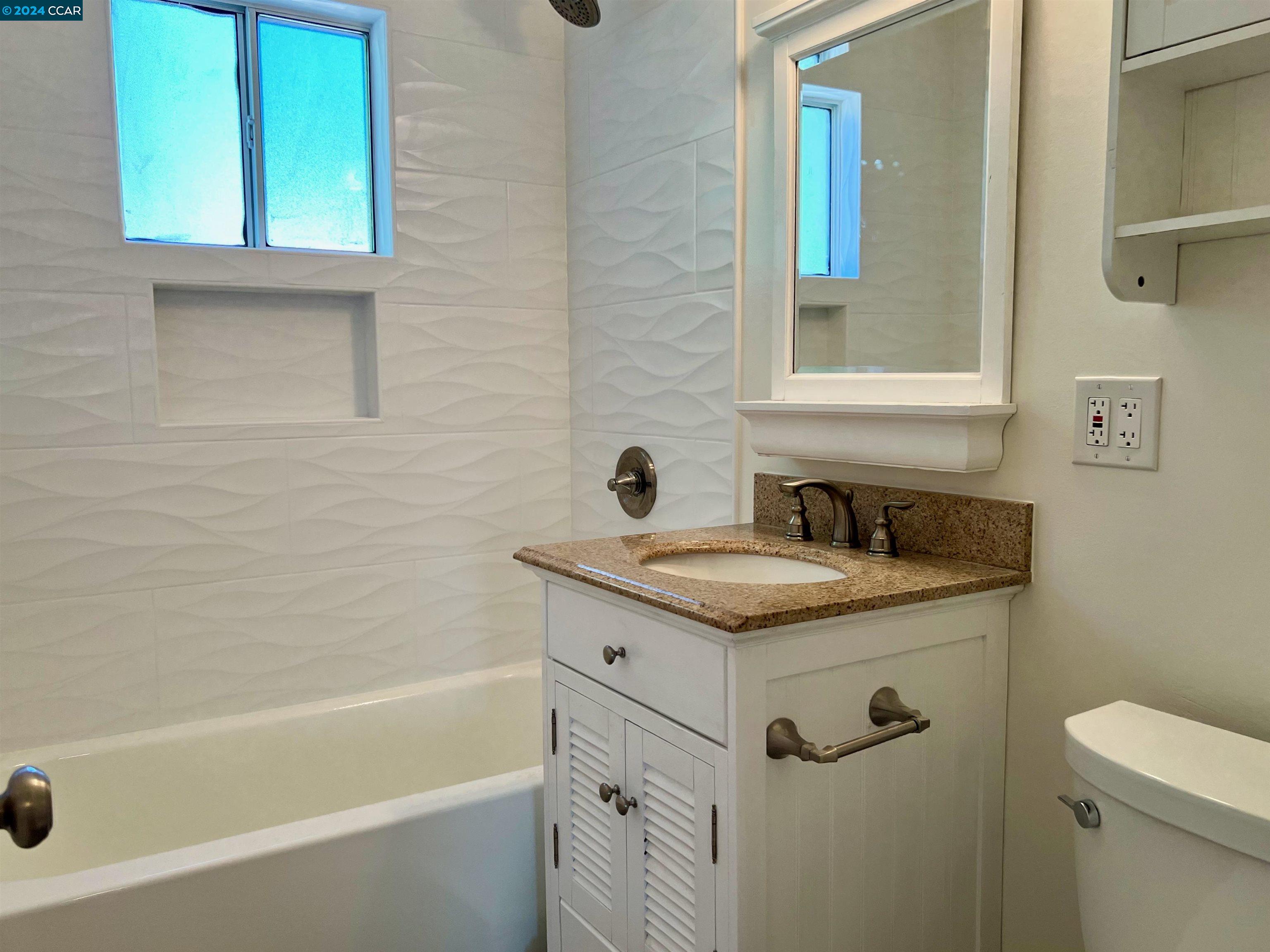 1282 Windermere Way Concord, CA 94521 - Photo 15 of 21 a bathroom with a granite countertop sink toilet and bathtub