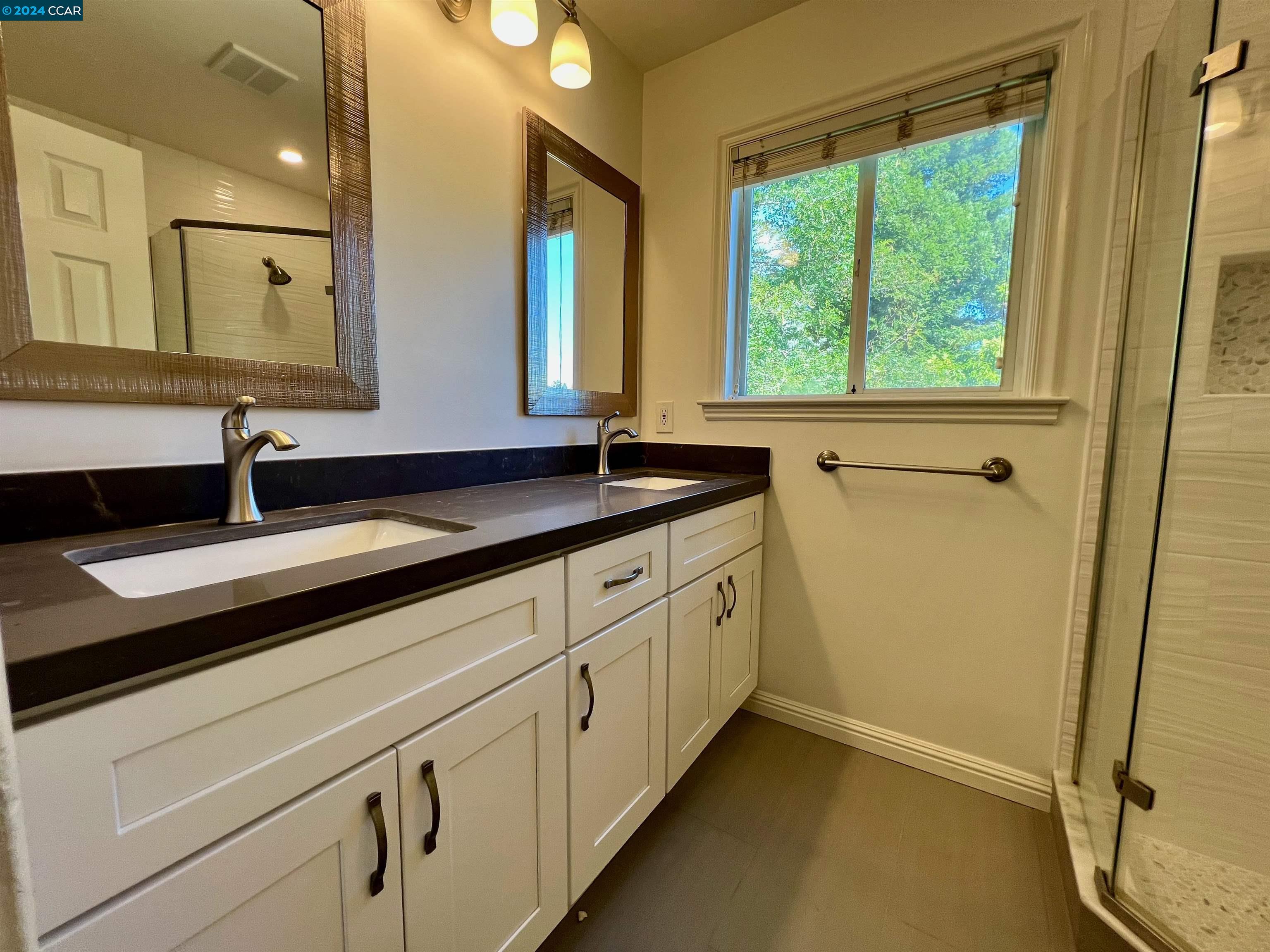 1282 Windermere Way Concord, CA 94521 - Photo 16 of 21 a bathroom with a granite countertop sink and a mirror