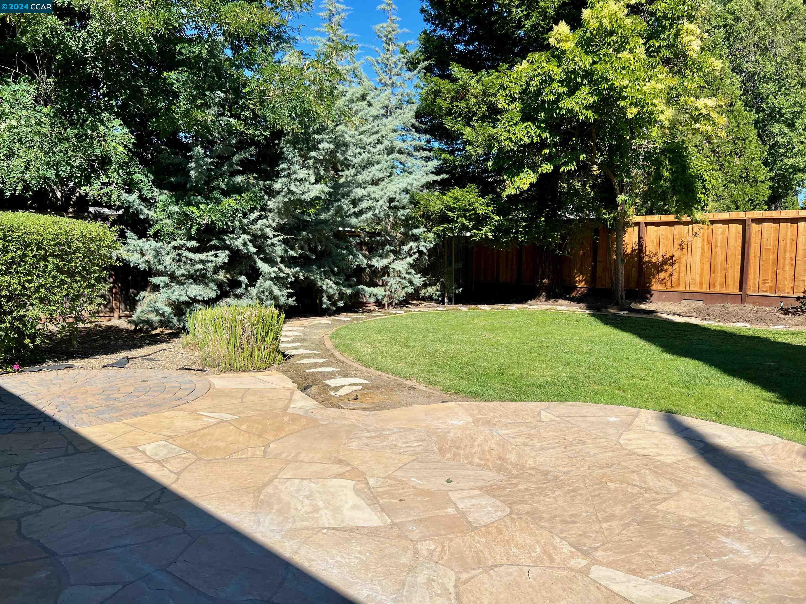 1282 Windermere Way Concord, CA 94521 - Photo 20 of 21 a view of a yard with a wooden fence