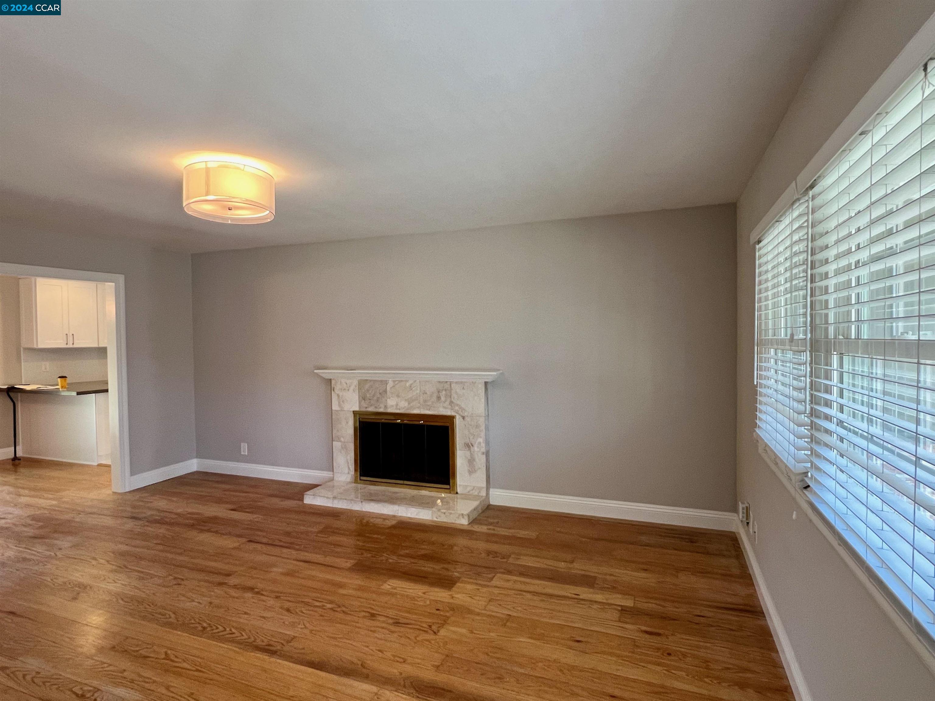 1282 Windermere Way Concord, CA 94521 - Photo 2 of 21 a view of an empty room with wooden floor and a window
