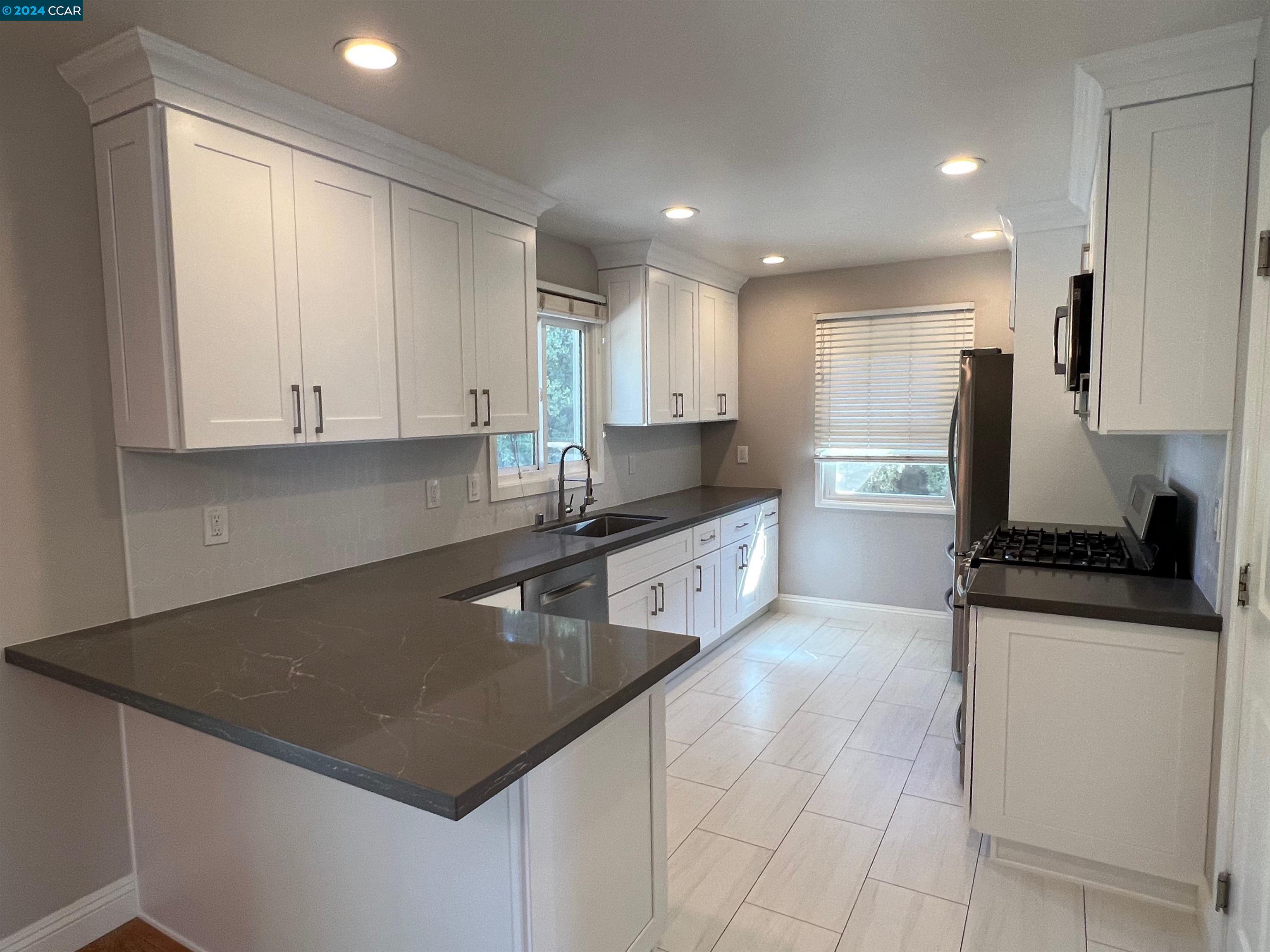 1282 Windermere Way Concord, CA 94521 - Photo 6 of 21 a kitchen with stainless steel appliances granite countertop a sink a stove and a refrigerator