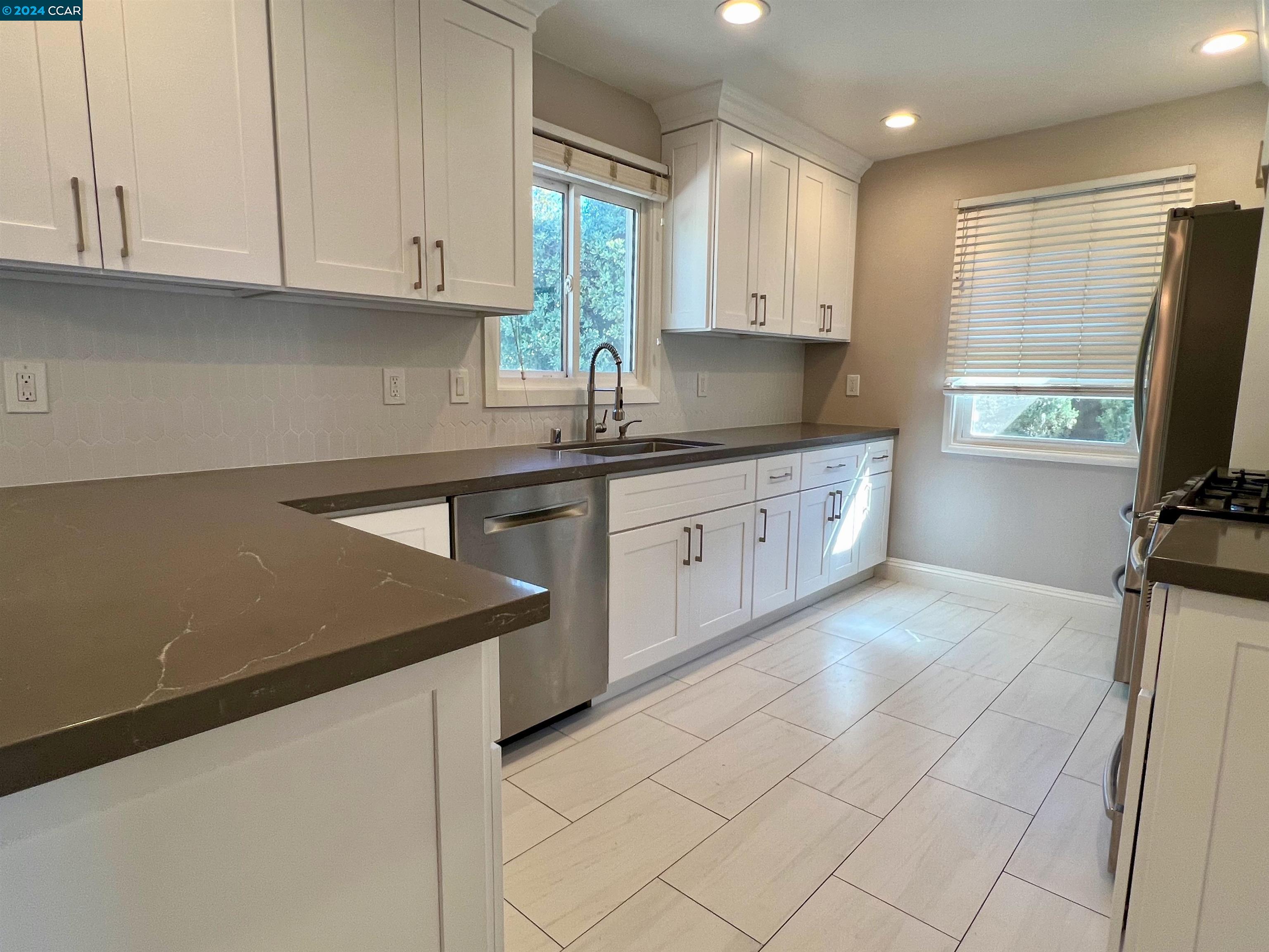 1282 Windermere Way Concord, CA 94521 - Photo 7 of 21 a kitchen with stainless steel appliances granite countertop a sink dishwasher stove and white cabinets