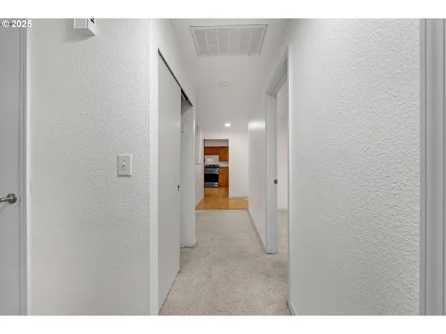 a view of a hallway with an entryway