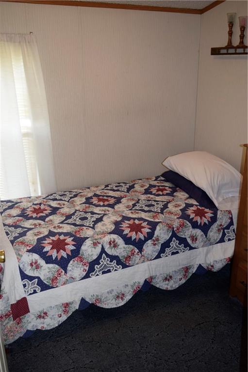 254 Piper Gross Road Latrobe, PA 15650 - Photo 18 of 42 a bed sitting in a bedroom next to a window