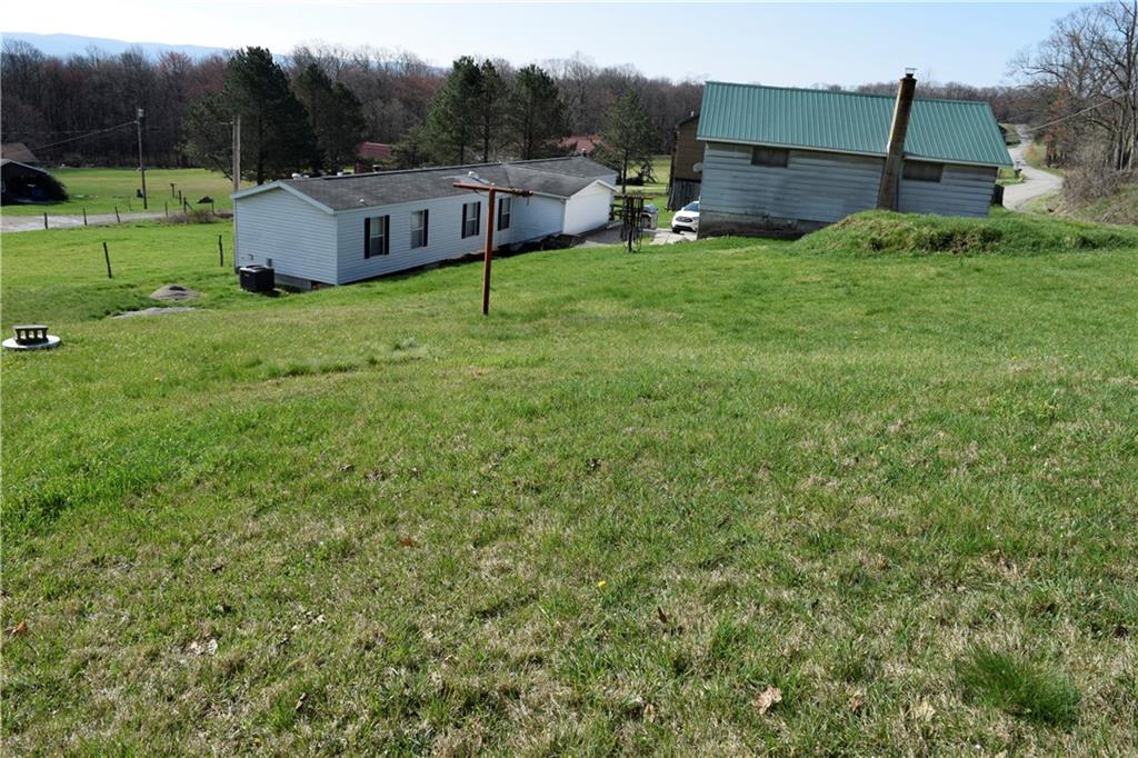 254 Piper Gross Road Latrobe, PA 15650 - Photo 2 of 42 a view of a house with a backyard and a garden