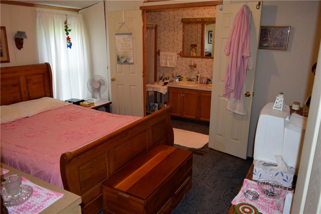 254 Piper Gross Road Latrobe, PA 15650 - Photo 24 of 42 a bedroom with a bed and wooden floor