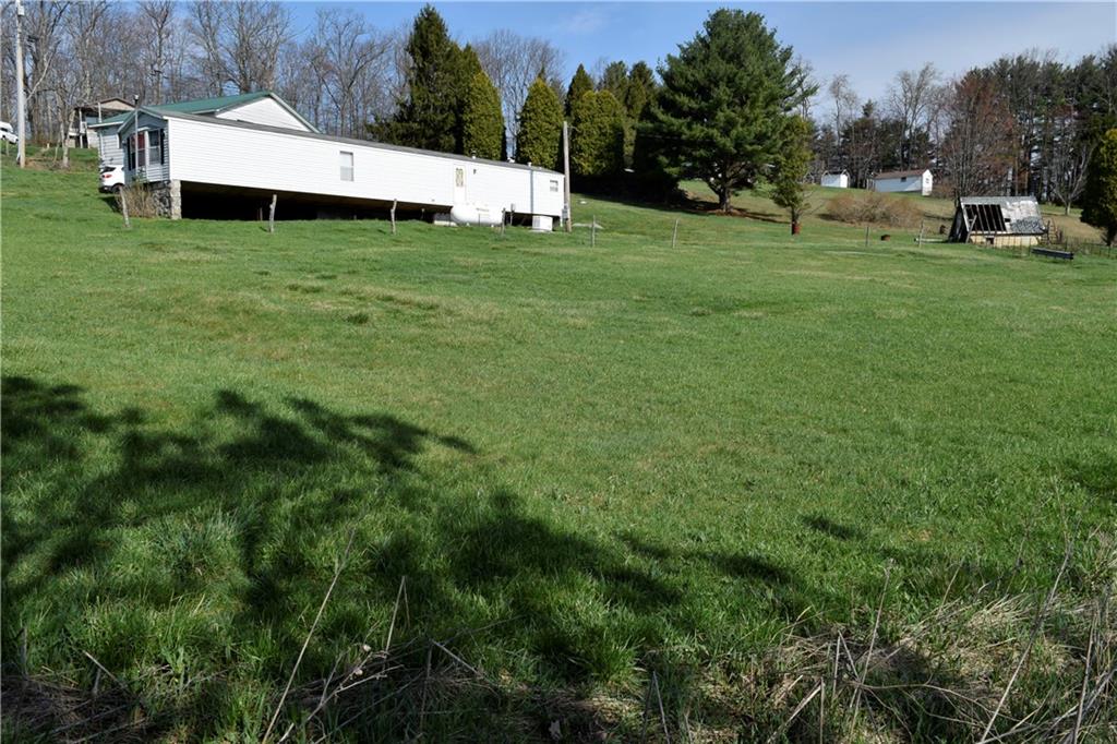 254 Piper Gross Road Latrobe, PA 15650 - Photo 6 of 42 a view of a house with a yard and sitting area