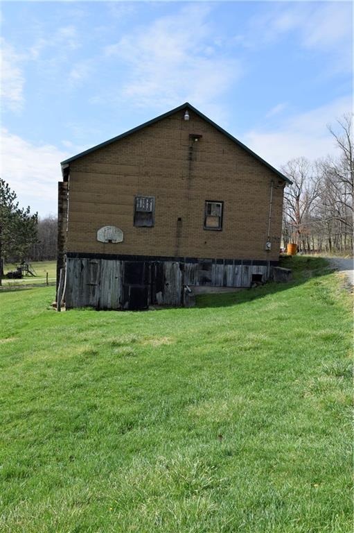 254 Piper Gross Road Latrobe, PA 15650 - Photo 10 of 42 a view of backyard with potted plants and wooden fence